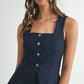 Mujer con cabello rubio viste un set de vest con cuello cuadrado y pantalon corto en color navy blue.